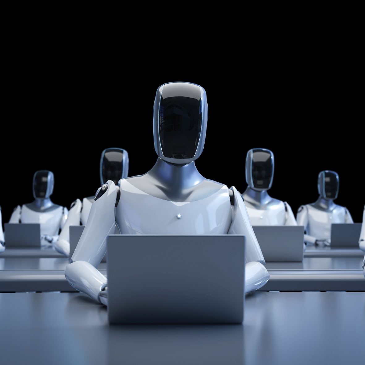 Futuristic humanoid robots seated in rows, working on laptops in a dark, high-tech environment—symbolising AI workforce, automation, and the future of business productivity.