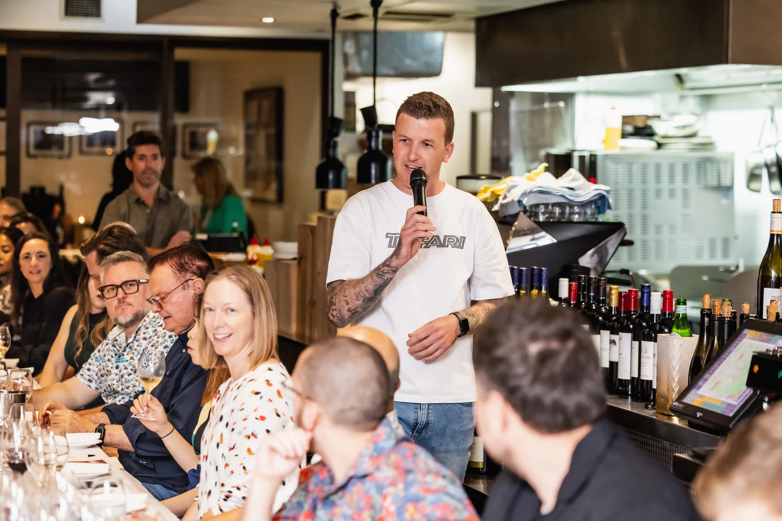 Brenden hosting a blind tasting for a room of guests at Lamonts Cottesloe