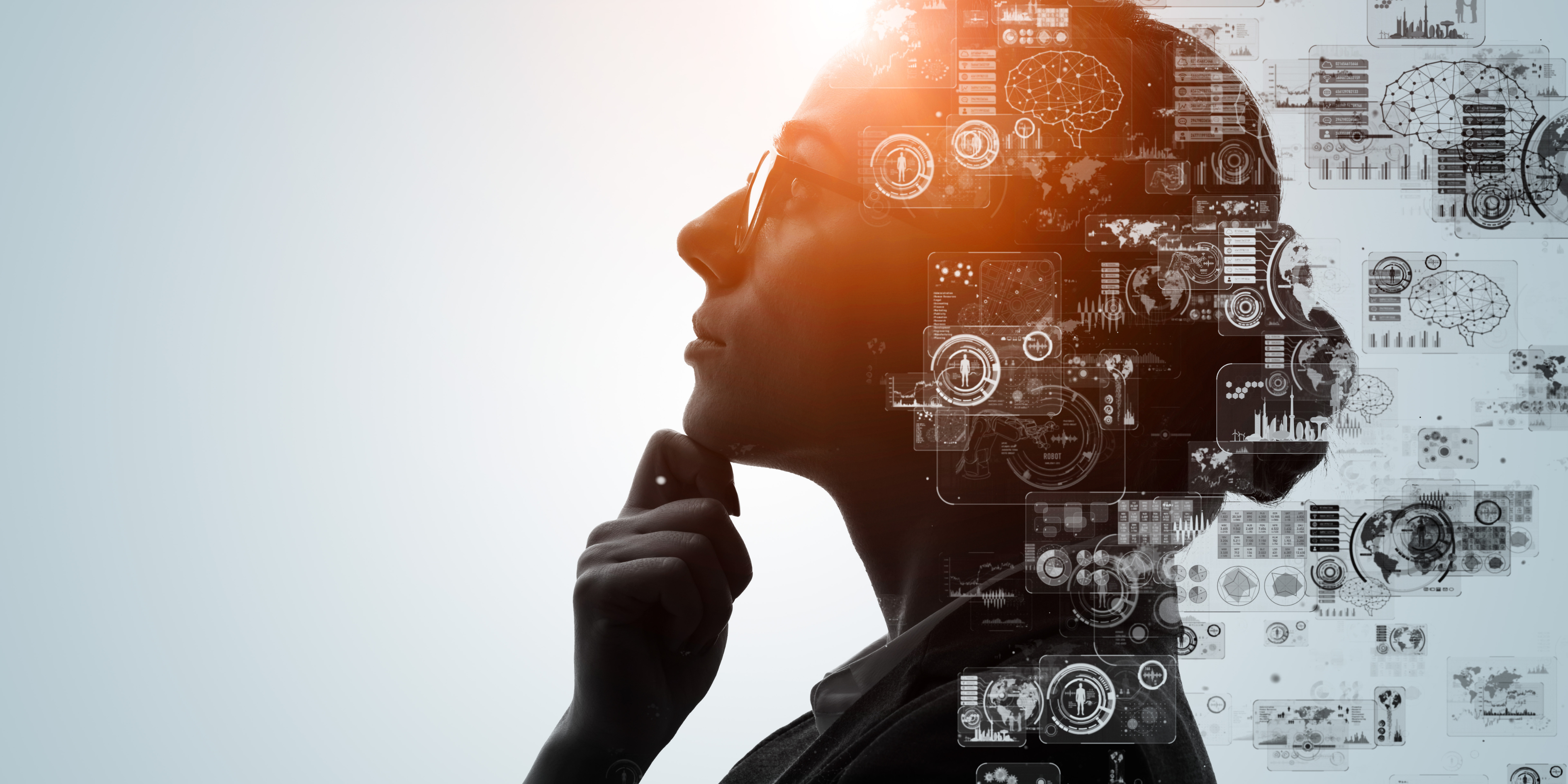 Silhouette of a thoughtful businesswoman overlaid with digital data graphics, symbolising technology, innovation, and AI-driven business services.